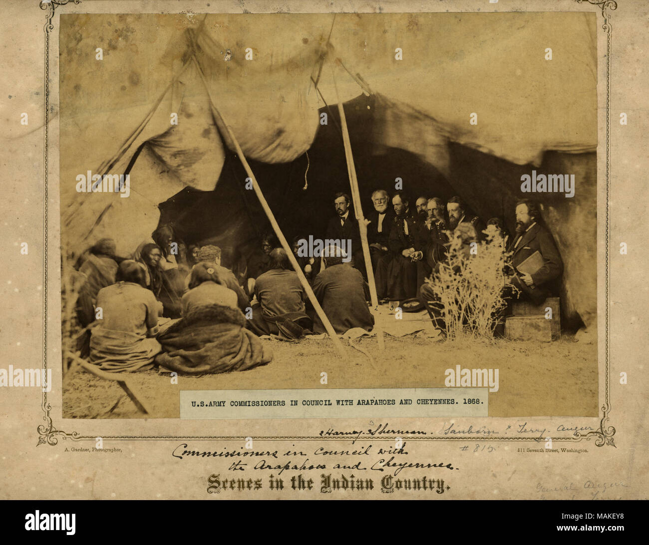 Group of American Indians and United States Army Commissioners in tent structure with wide, staked-up opening; Indians sit on ground at left, and Commissioners at right on boxes. General William S. Harney and General William T. Sherman are among the Commissioners. Harney first served under Andrew Jackson in 1818 as a second lieutenant. He was sent to Nebraska Country to fight the Sioux after what is called the Grattan Massacre. His battles against the Sioux became known as the 'Battle of Ash Hollow.' After the Sioux were defeated they referred to Harney as the 'Woman Killer.' Sherman first ser Stock Photo