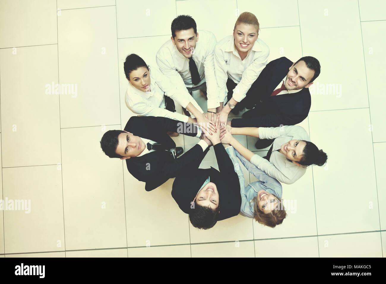 business people group joining hands and stay as team in circle and ...