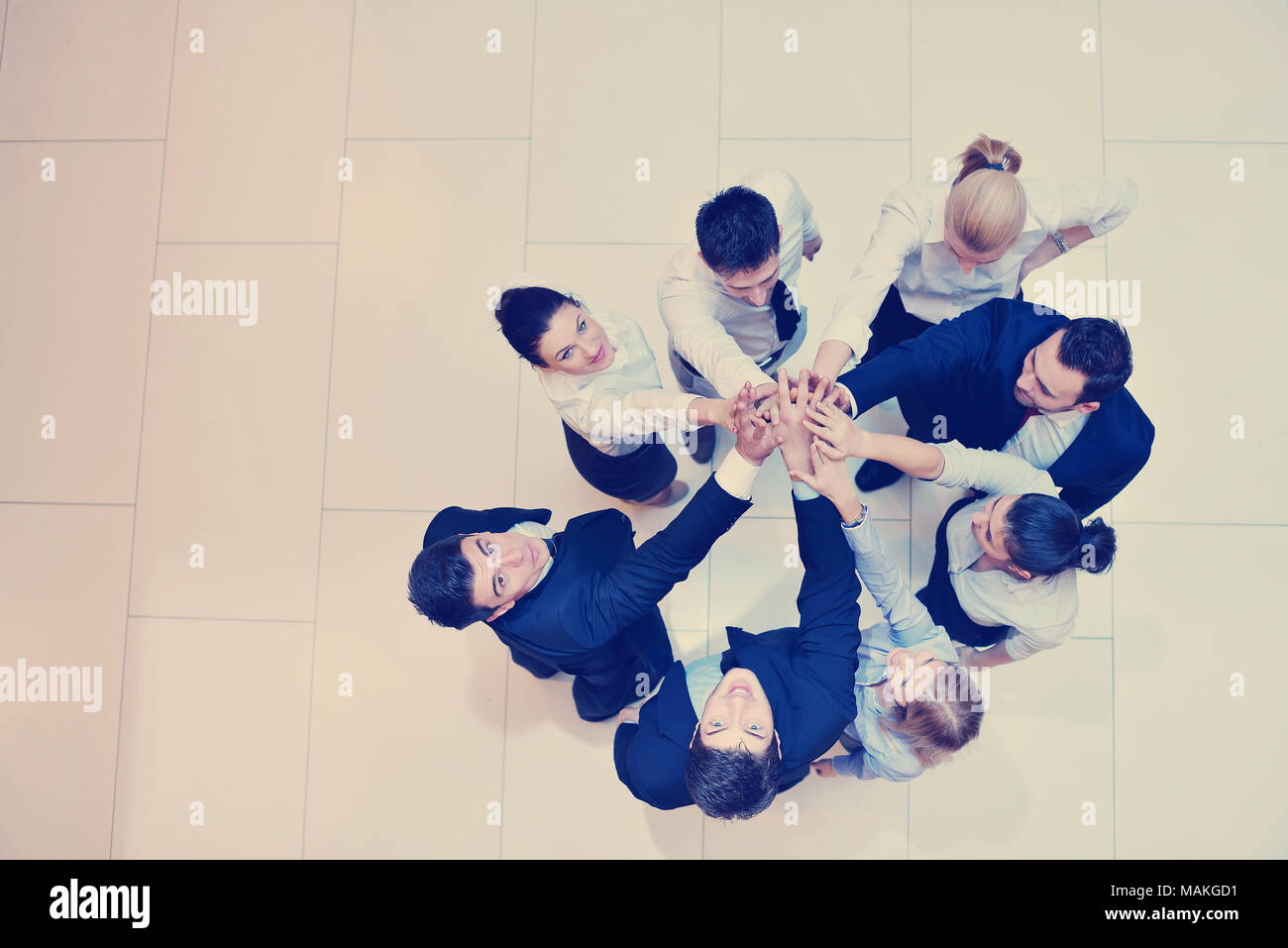 business people group joining hands and stay as team in circle and ...