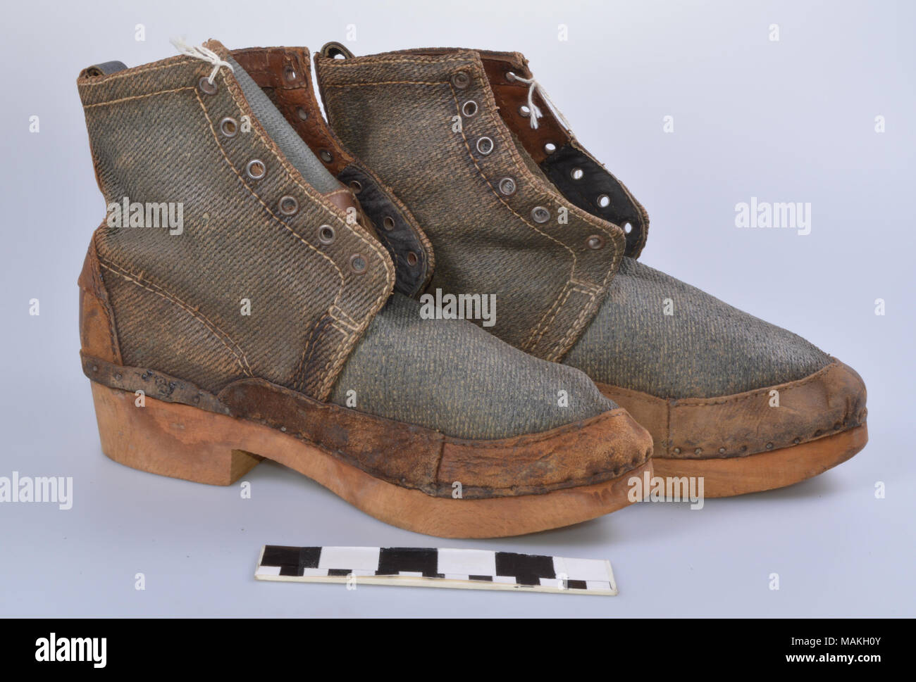 Pair of men's short boots made of canvas, leather and wood. Soles are solid wood and have a 1 1/2 inch heel. Eyelets on sides for laces. Taken from a German Army material dump in Wolsfeld, Germany by James Marsh Douglas during World War I. Title: German Canvas Wood Sole Military Boots  . 1918. Stock Photo