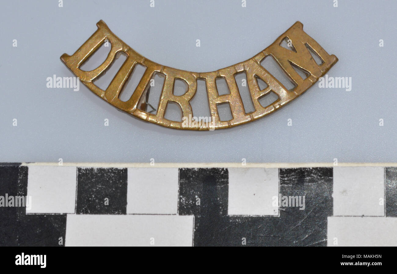 World War I Durham Light Infantry Regiment brass shoulder title in the shape of the word DURHAM, curved upwards at each end. Title: World War I Durham Light Infantry Regiment Shoulder Title  . after 1881. Stock Photo