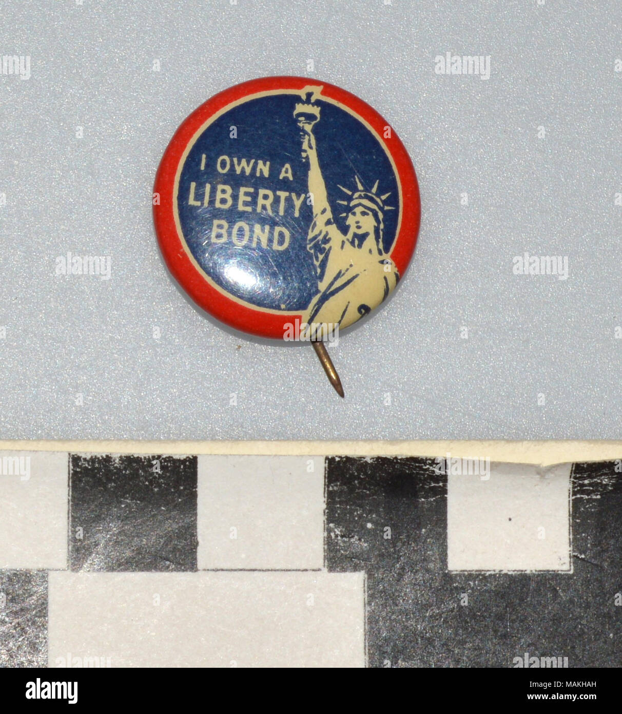 World War I Liberty Loan pin, round blue pin with red border features the words 'I Own A Liberty Bond' and an image of the Statue of Liberty. Given to someone who purchased a Liberty Loan or volunteered or supported the effort. Title: World War I Liberty Bond Pin  . between 1916 and 1919. Stock Photo