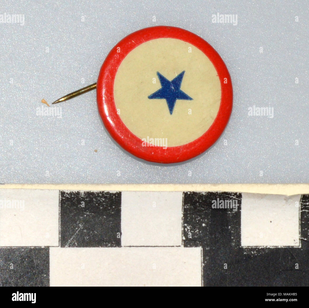 World War I era in service pin with red border, white circle with blue star in the center. Form of the Service Flag, representing a loved ones serving in the military. Title: World War I In Service Pin  . between 1916 and 1919. Stock Photo