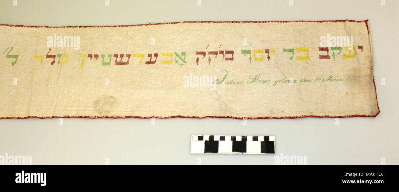 Wimpel belonging to Julius Stern, born 1873. Made of white cloth with multi-colored fabric painting. If traditionally made, this was the cloth used for swaddling at Stern's bris milah, then refashioned and decorated, and used to bind the Torah at the Synagogue. Title: Wimpel of Julius Stern  . 1873. Stock Photo
