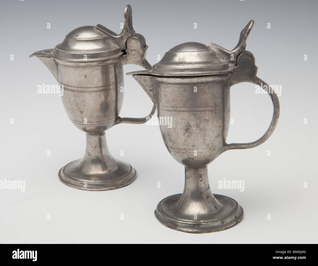 Pair of side handled pewter casters or cruets believed to have been used in first Catholic Church in New Madrid, Missouri. Title: Pair of Casters for Catholic Mass  . circa 1790. Stock Photo