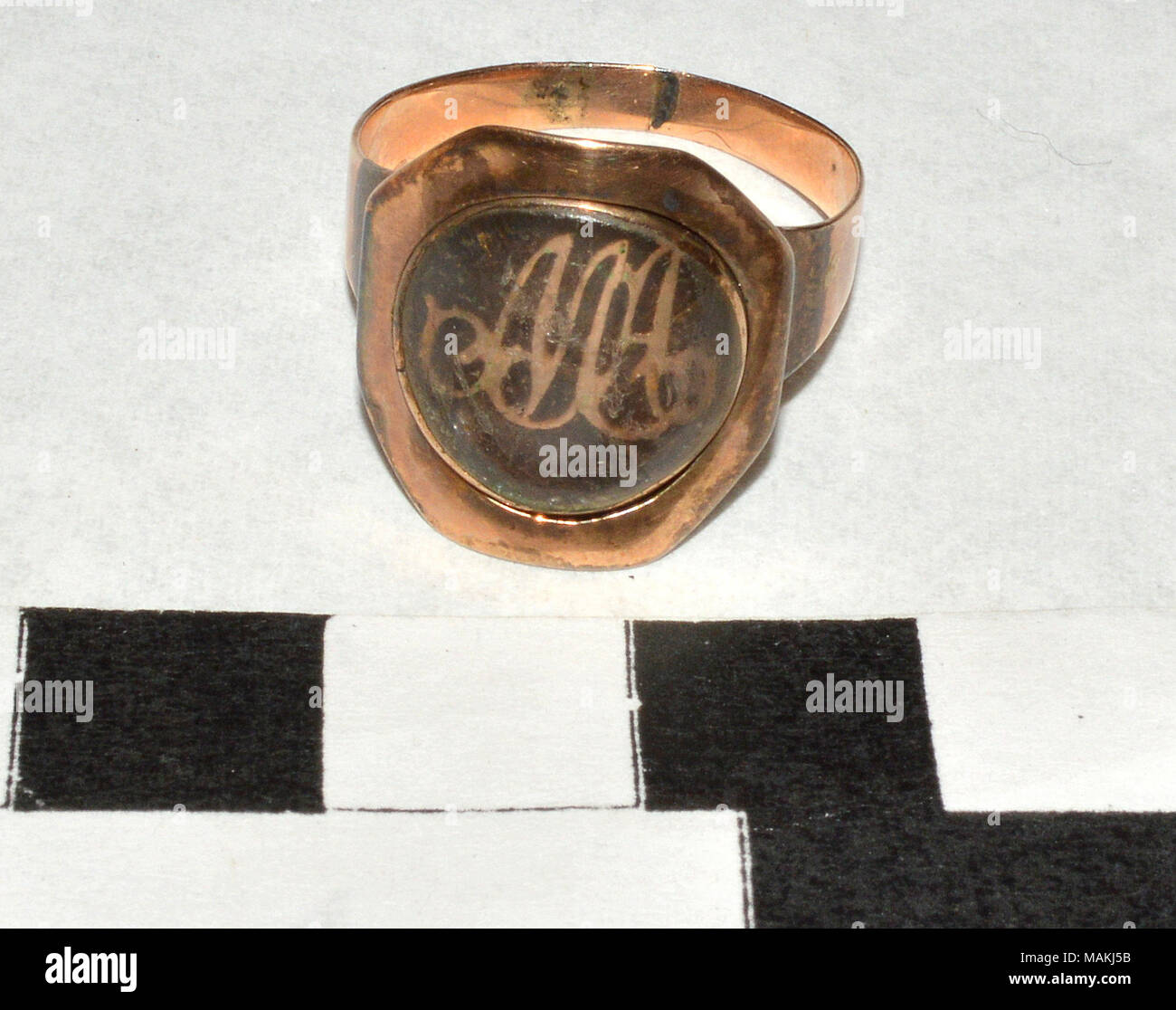 Gold mourning ring with locks of brown hair and insert letters 'MA' for Margaret Austin. Title: Mourning Ring Honoring Margaret Austin  . 1824. Stock Photo