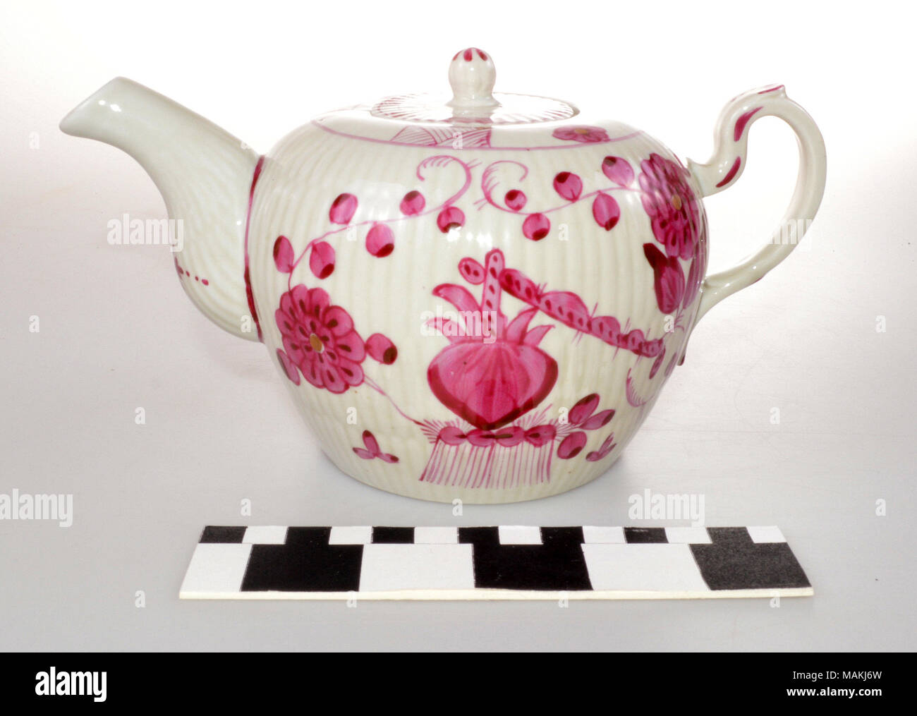 White china teapot painted with red flowers. Attributed to Wallendorf Porcelain. Title: China Teapot with Red Flowers  . circa 1778. Wallendorf Porcelain Stock Photo