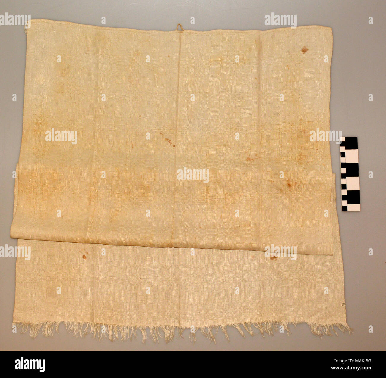 White linen towel woven with a rectangular geometric design. Title: White Linen Hand Towel  . circa 1810. Stock Photo