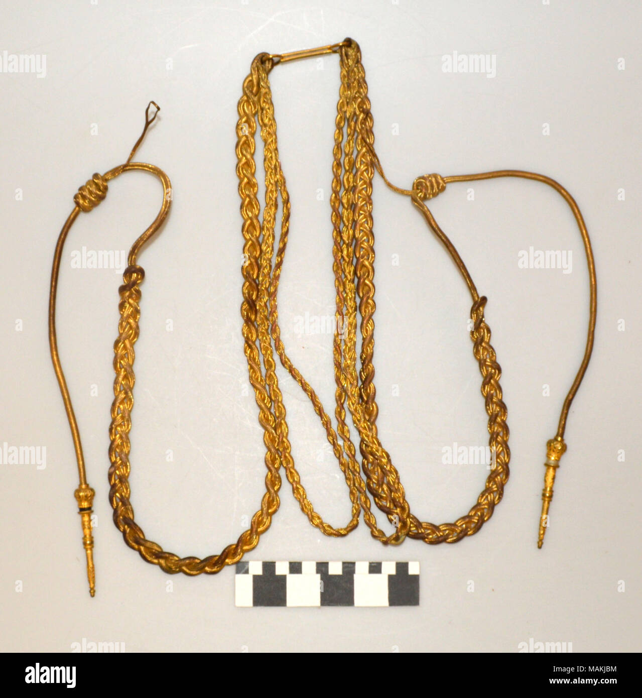 Gold braided aiguillette with decorative tips at the end. Title: Gold Braided Aiguillette  . between 1860 and 1880. Stock Photo