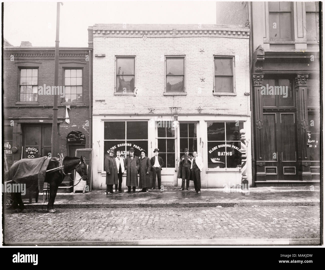 Horizontal Black And White Photograph Showing A Small Group Of