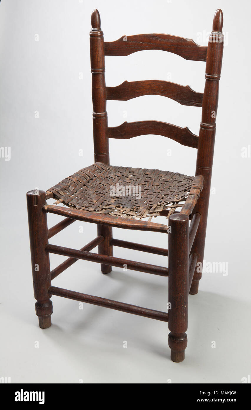 French colonial side chair with shaped back slats and woven hickory bark seat. The shaped back rails and back splats make this chair the most finely worked of MHM's small collection of French colonial chairs. Title: French Colonial Style Slat Back Chair  . circa 1800. Stock Photo