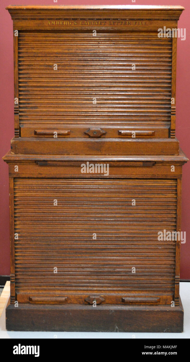 Amberg's Cabinet Letter File, oak, 2-piece, stacked filing cabinet, each section with sliding tambour covers. Title: Amberg's Cabinet Letter File  . circa 1880. Amberg Letter & File Co. Stock Photo