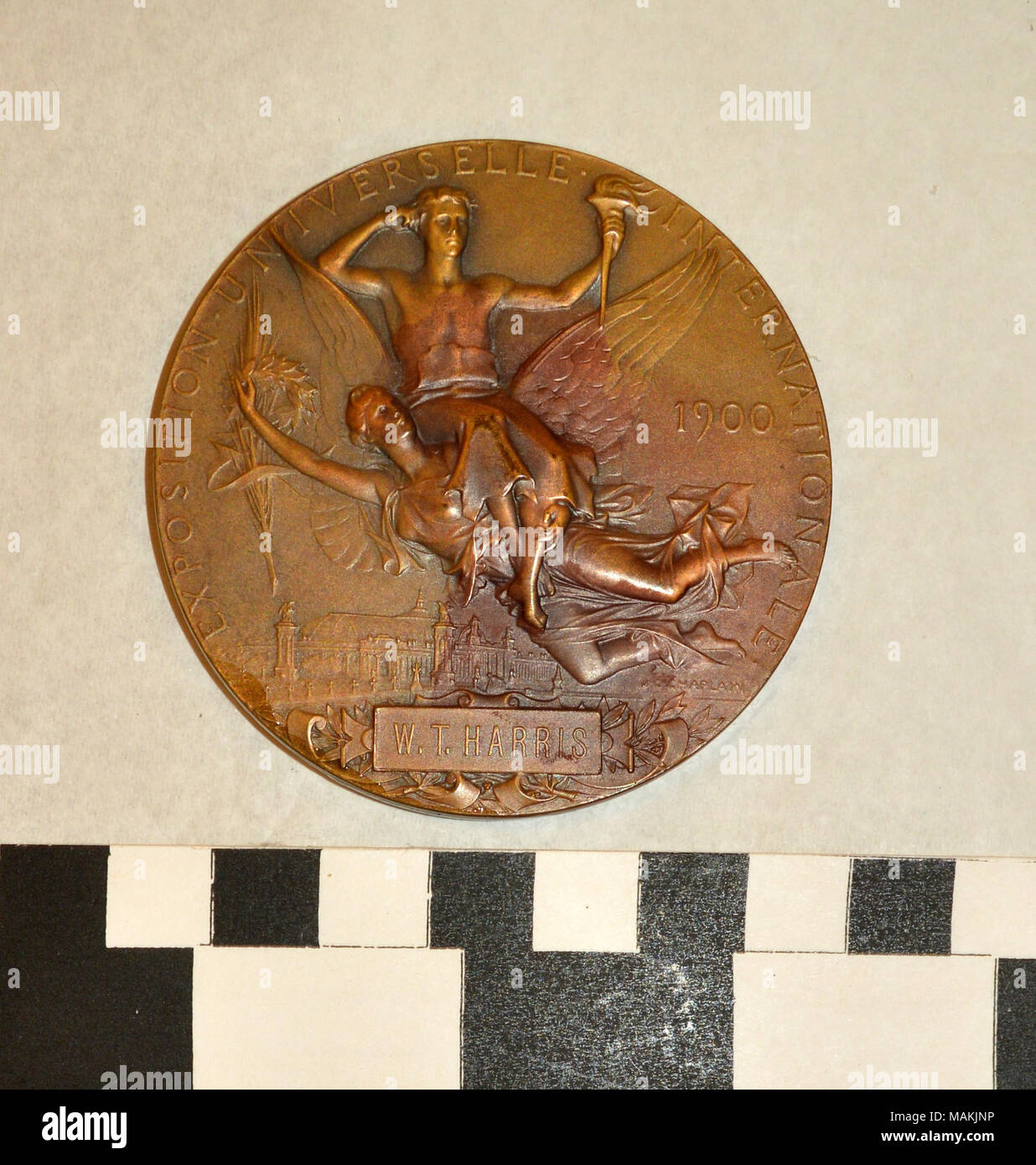 Bronze award medal; obverse has wreathed bust of woman with tree and city in background; reverse has angel carrying man over city Title: 1900 Paris World's Fair Souvenir Medal, France  . 1900. J.C. (sculptor) Chaplain Stock Photo