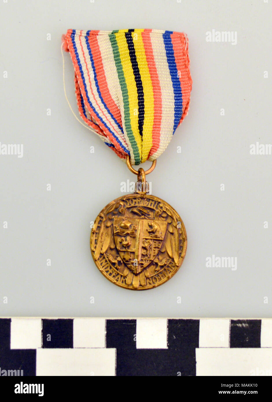 American War Medal, Issued by the American Fund for French Wounded commemorating the entrance of the United States into World War I. Medal has attached a multicolored, striped ribbon attached. Title: American War Medal, Issued by the American Fund for French Wounded  . circa 1914. Whitehead and Hoag Company, Newark, NJ Stock Photo