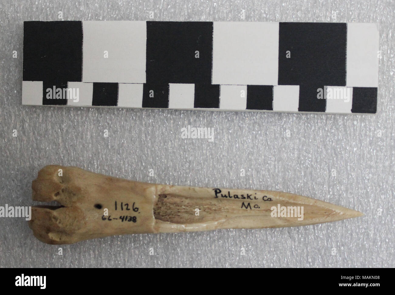 Native American bone awl used to work leather; worn from use. Title