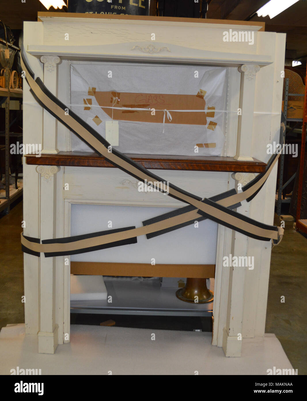 White Painted Wooden Mantel With Double Shelves And Iron Fireplace