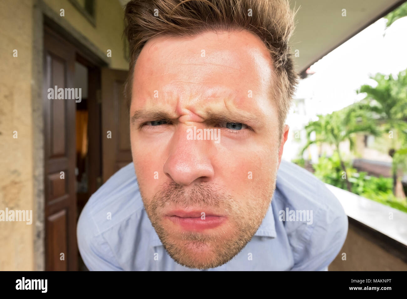 Closeup portrait of caucasian man. He is suspecting that somebody is spying and watching on him. Stock Photo