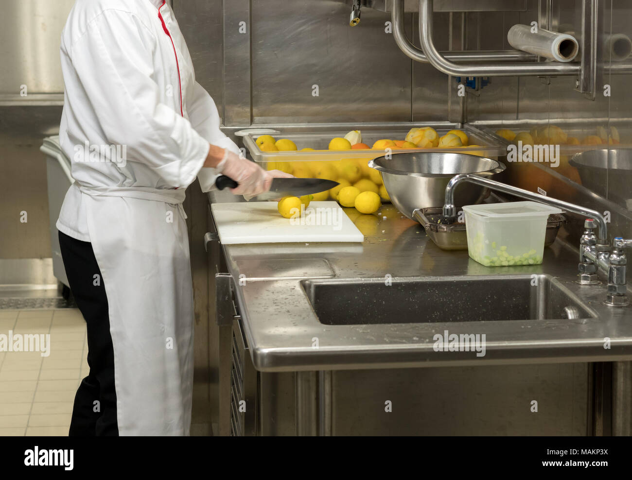 Chef preparing fruit in commercial kitchen Stock Photo