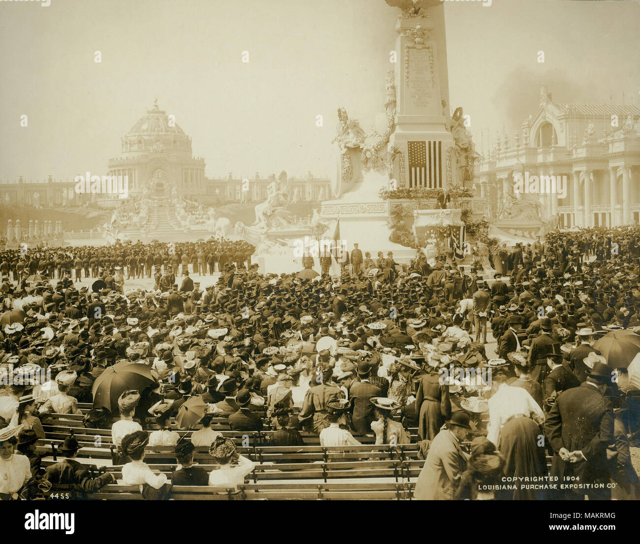 Title: Section of crowd in reserved seats listens to the address of Louisiana Purchase Exposition President David R. Francis on Opening Day of the 1904 World's Fair.  . 1904. Official Photographic Company Stock Photo