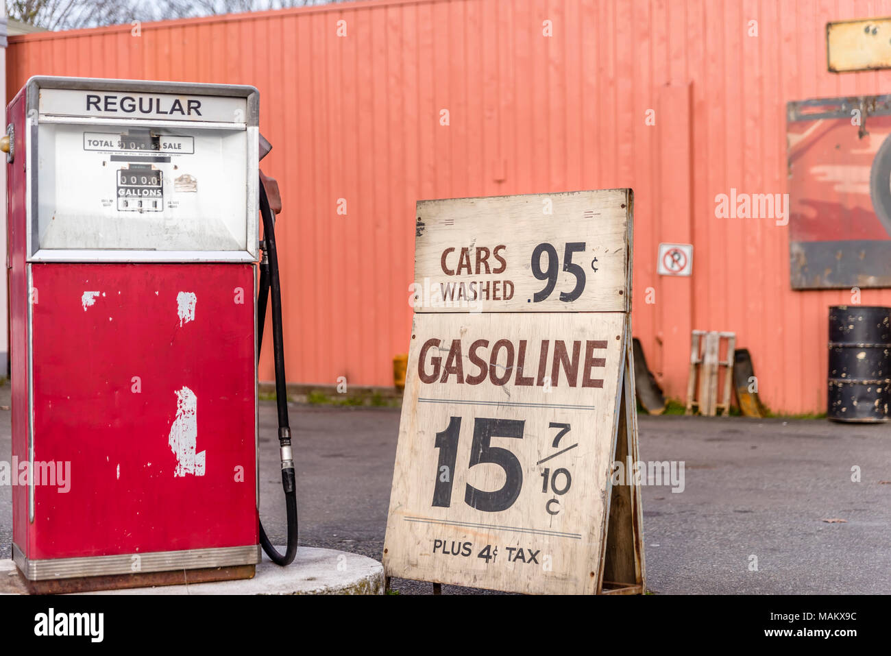 old car gas station, advertising for cheap gasoline, metal barrel in summer day Stock Photo