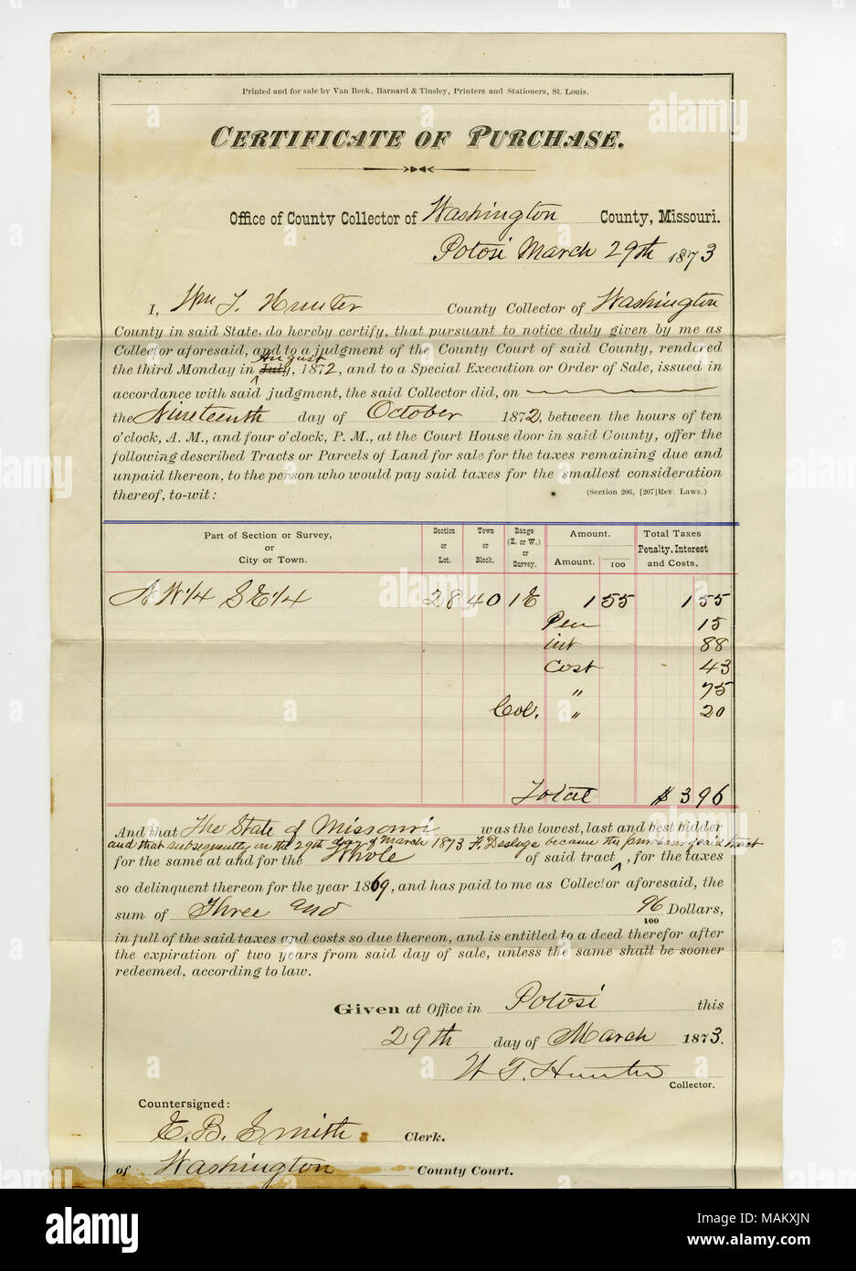 Purchase of property from county for past due taxes by F. Desloge in the amount of $3.96 at Potosi, 1 parcel described as NW 1/4 SE 1/4 Section or Lot 28, Town or Block 40, Range or Survey 1E in Washington County. Title: Certificate of purchase signed W.T. Hunter, Collector of Washington County, March 29, 1873  . 29 March 1873. Hunter, W.T. Stock Photo