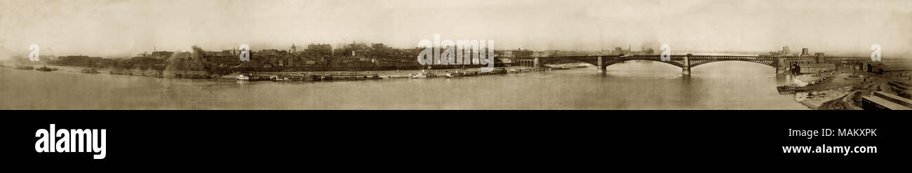 Horizontal, sepia panorama of the St. louis riverfront taken from the Illinois shore. The Eads Bridge is on the right side of the print. Title: St. Louis Riverfront, 1903-1910 panorama.  . between 1903 and 1910. Stock Photo