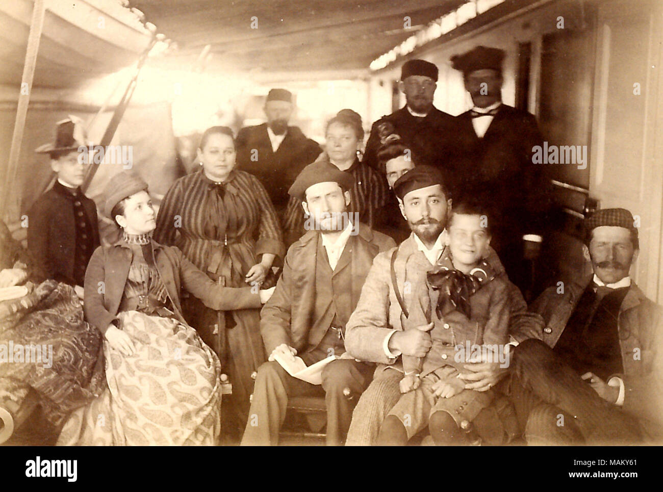 Title: 'Gruppe an Bord der Fulda,' showing a group of passengers, including Wilh. Mallinckrodt, crossing the Atlantic on board the steamer Fulda  . 1888. Stock Photo