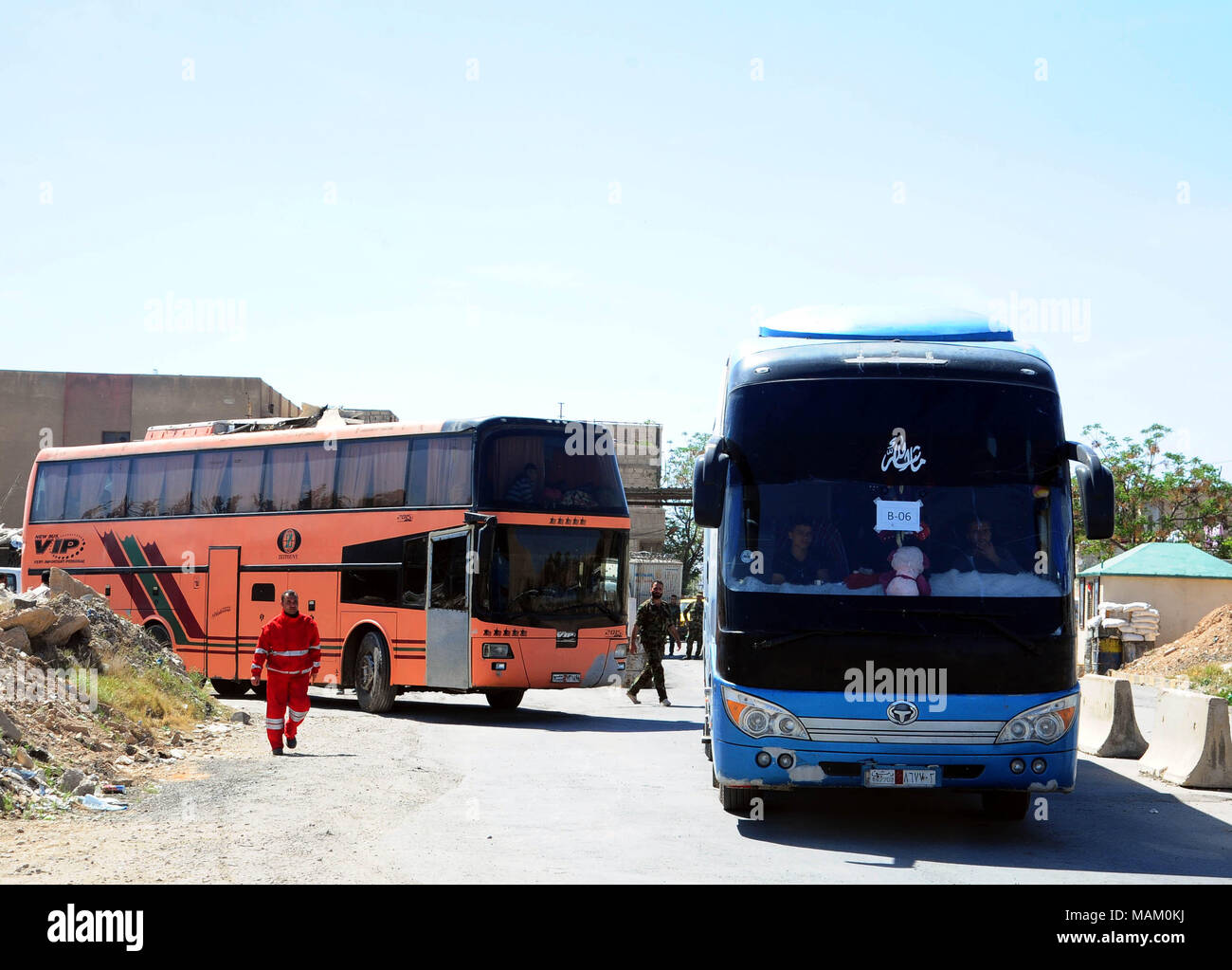 Damascus, Syria. 2nd Apr, 2018. Buses transporting militants of the Islam Army and their families leave the district of Douma in Eastern Ghouta through a crossing point in Wafideen area, northeast of Damascus, Syria, on April 2, 2018. Some 1,146 militants of the Islam Army and their families departed the Douma district in Eastern Ghouta toward the rebel-held Jarablus city in the north, marking the first batch of this rebel group to evacuate their main stronghold near Damascus, according to the state news agency SANA. Credit: Ammar Safarjalani/Xinhua/Alamy Live News Stock Photo