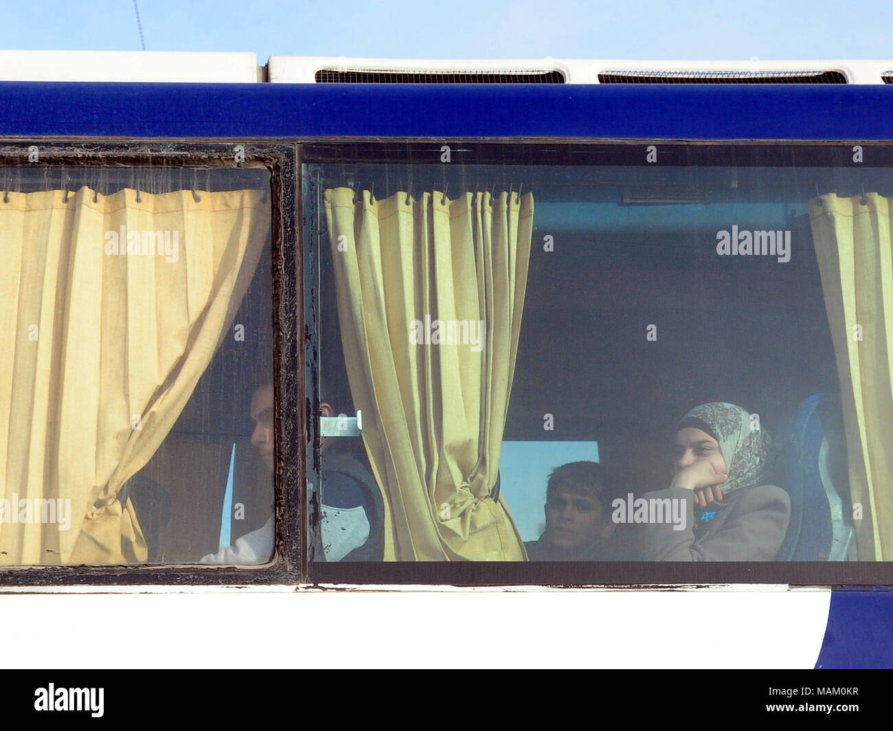 Damascus, Syria. 2nd Apr, 2018. Family members of Islam Army are seen on a bus departing the district of Douma in Eastern Ghouta through a crossing point in Wafideen area, northeast of Damascus, Syria, on April 2, 2018. Some 1,146 militants of the Islam Army and their families departed the Douma district in Eastern Ghouta toward the rebel-held Jarablus city in the north, marking the first batch of this rebel group to evacuate their main stronghold near Damascus, according to the state news agency SANA. Credit: Ammar Safarjalani/Xinhua/Alamy Live News Stock Photo