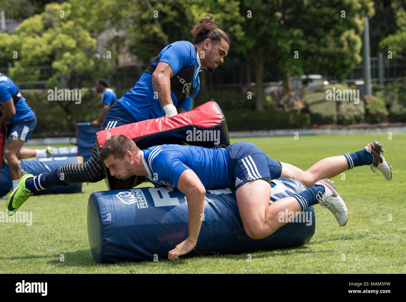 HONG KONG,HONG KONG SAR,CHINA:April 3rd 2018. The USA Rugby team conduct a training session at So Kon Po recreation ground ahead of their Hong Kong Rugby 7's matches. Brett Thompson (bottom) break past the the tackling bag of Folau Niua .Alamy Live News Stock Photo