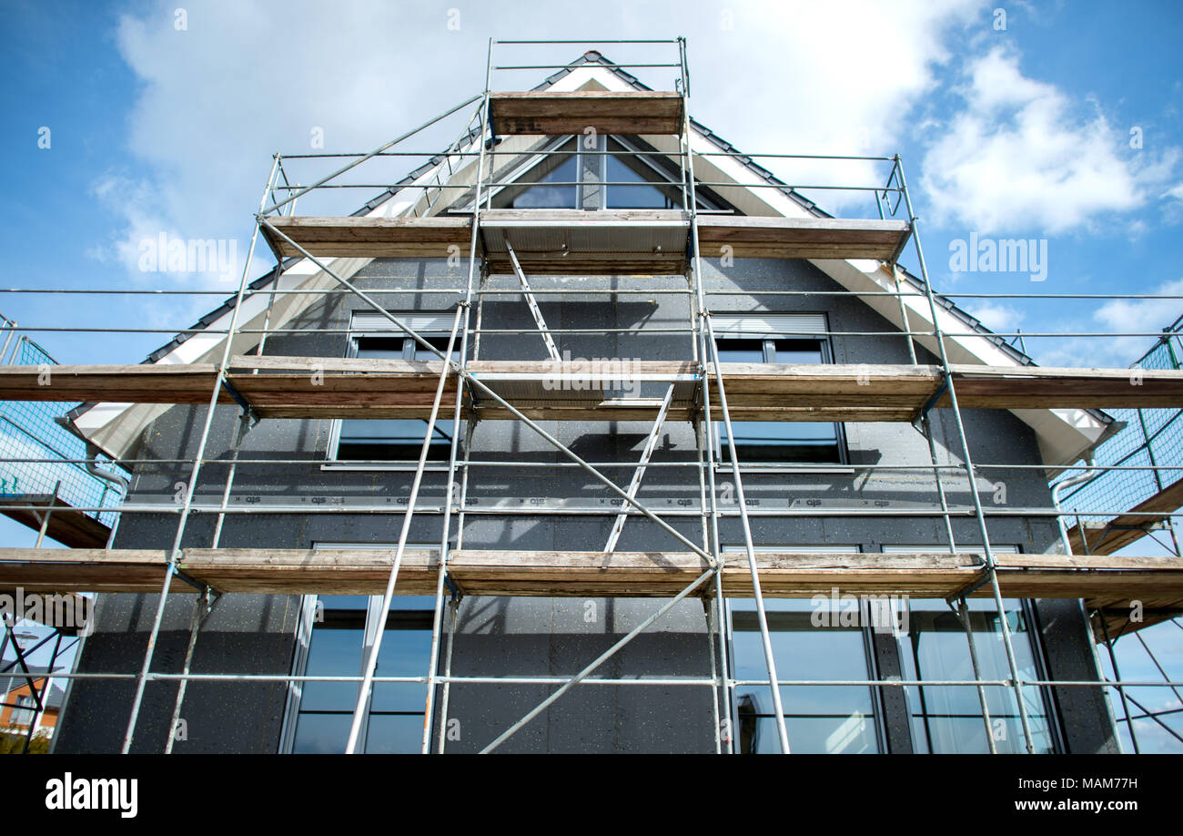 21 March 2018, Germany, Leiferde: A house' shell construction surrounded by scaffolding in a new residential area. Photo: Hauke-Christian Dittrich/dpa Stock Photo