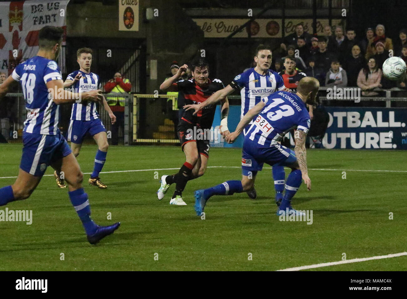 Seaview, Belfast, Northern Ireland, UK. 03 April 2018. Danske Bank Premiership - Crusaders 1 Coleraine 1. In tonight's top of the table clash at a packed Seaview, Crusaders drew 1-1 with Coleraine. The draw keeps Crusaders top of the league, two points ahead of Coleraine with four games to play. Crusaders Philip Lowry (7) fires in a shot. Credit: David Hunter/Alamy Live News. Stock Photo