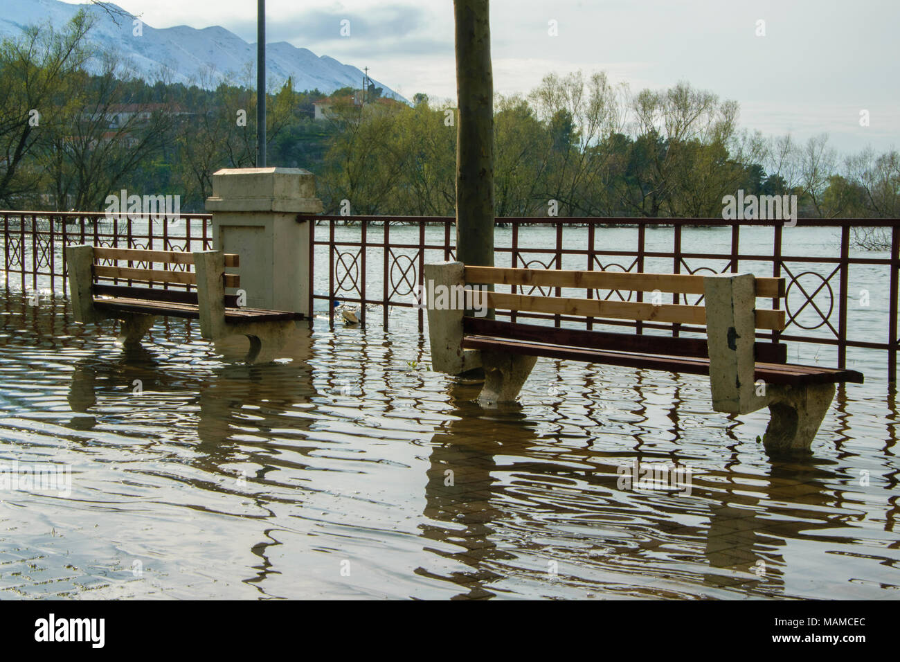Raised water level from the river arrives on the sidewalk, concept - bad weather conditions Stock Photo