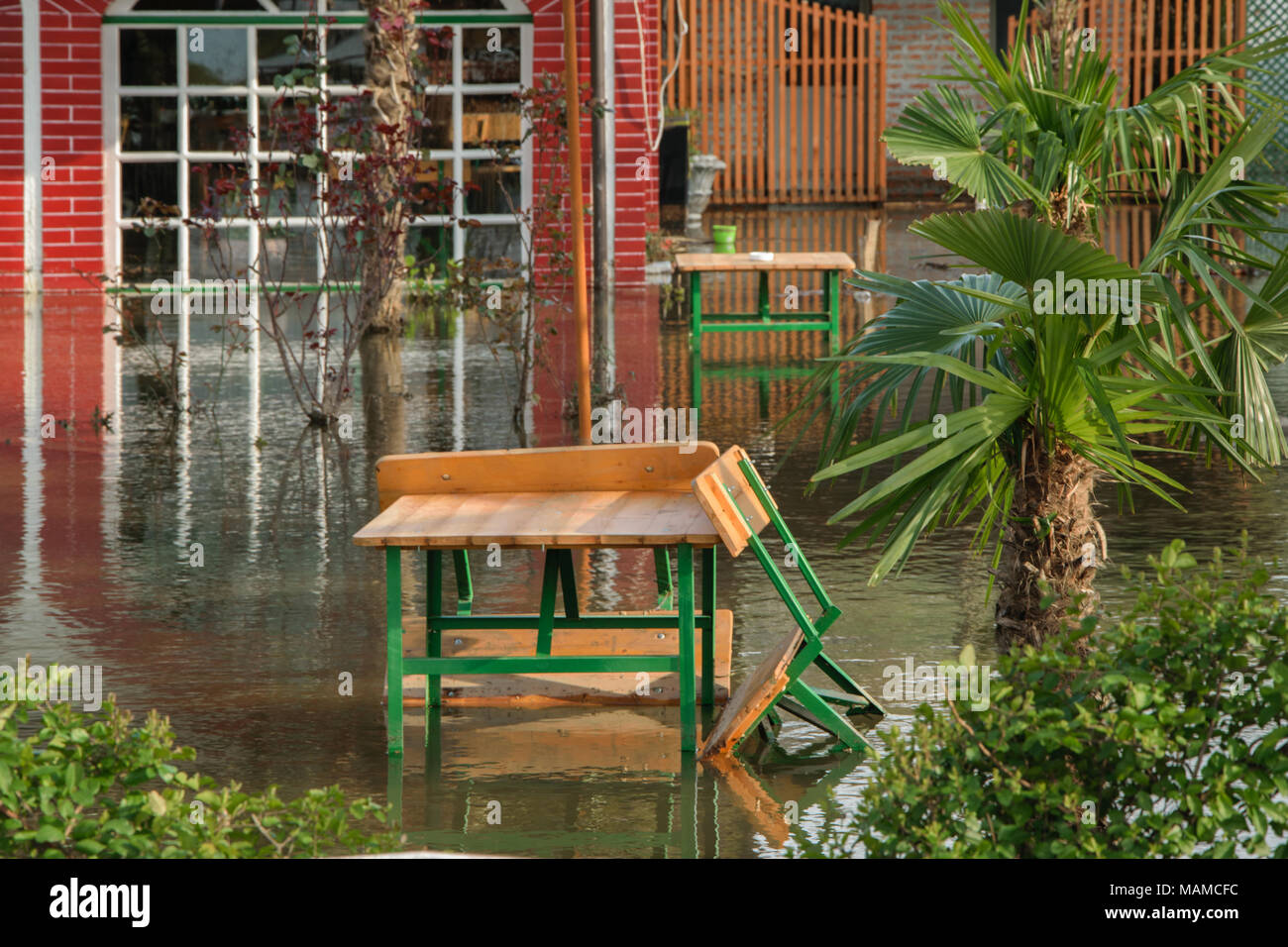 The increased level of water from rains in the front yard house, concept - bad weather conditions Stock Photo
