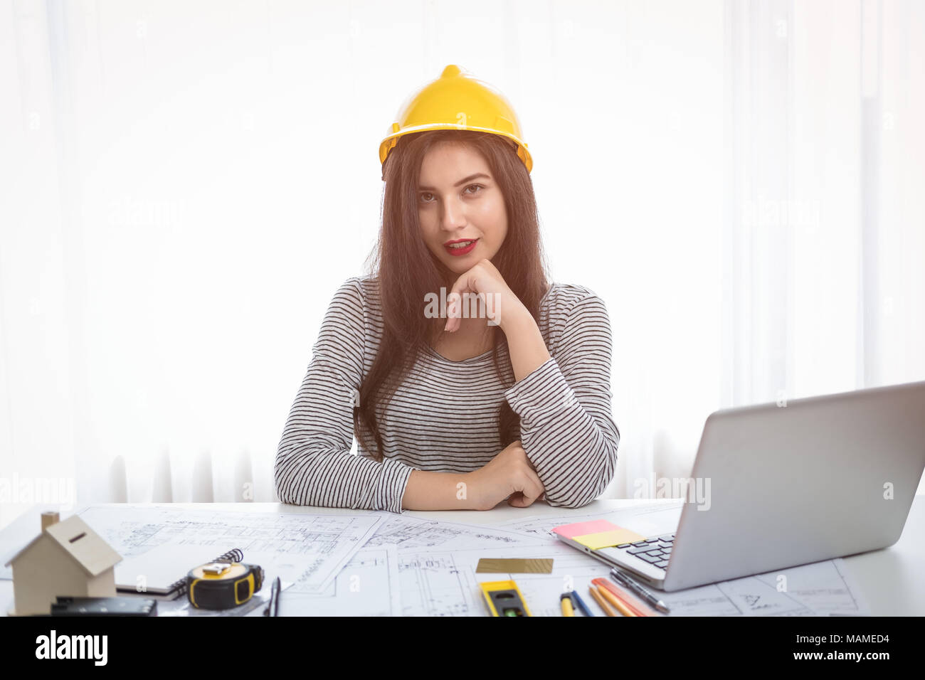 Architect or planner working on drawings for construction plans at a table Stock Photo