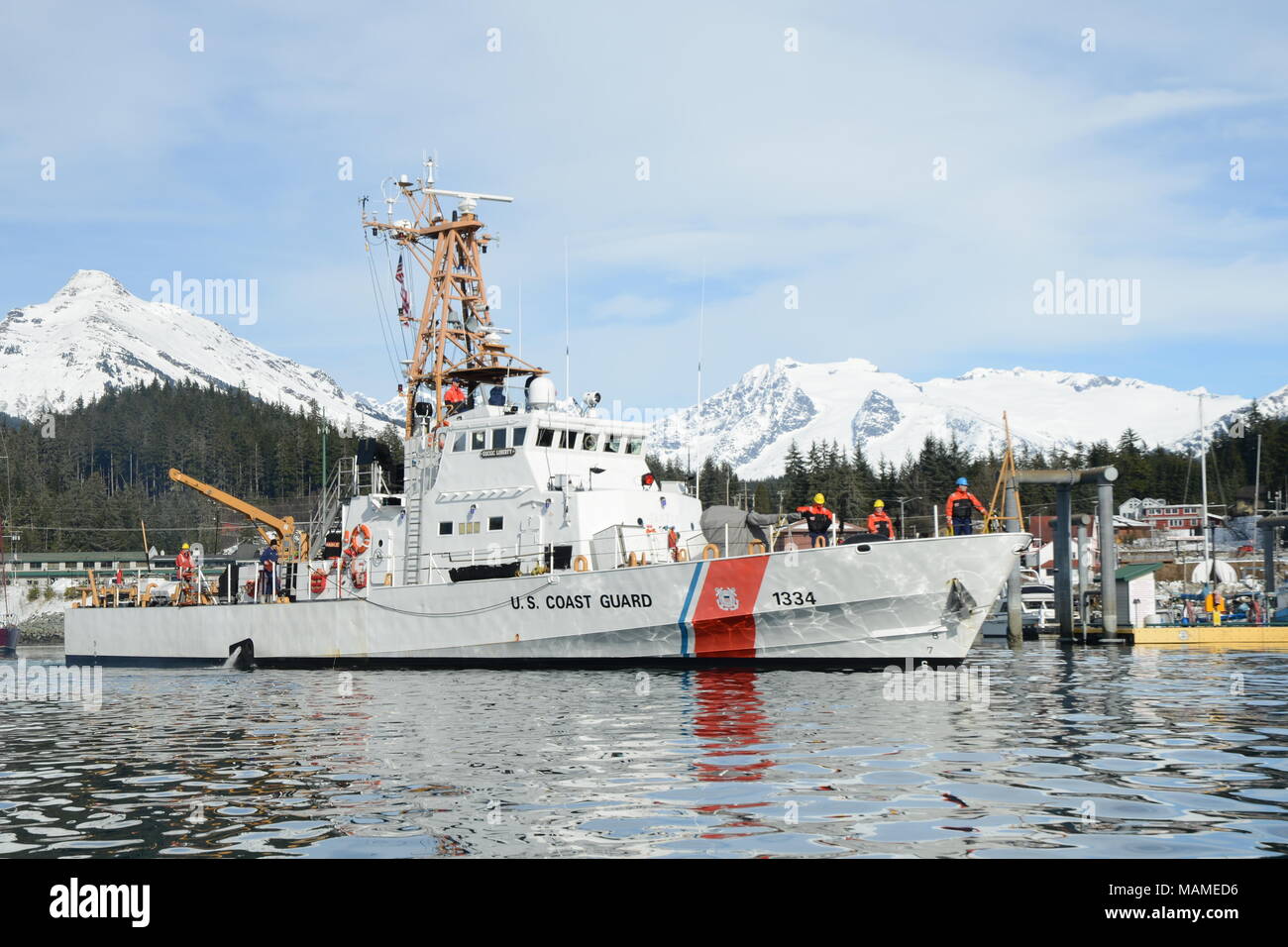 The crew of the Coast Guard Cutter Liberty prepares to moor at their