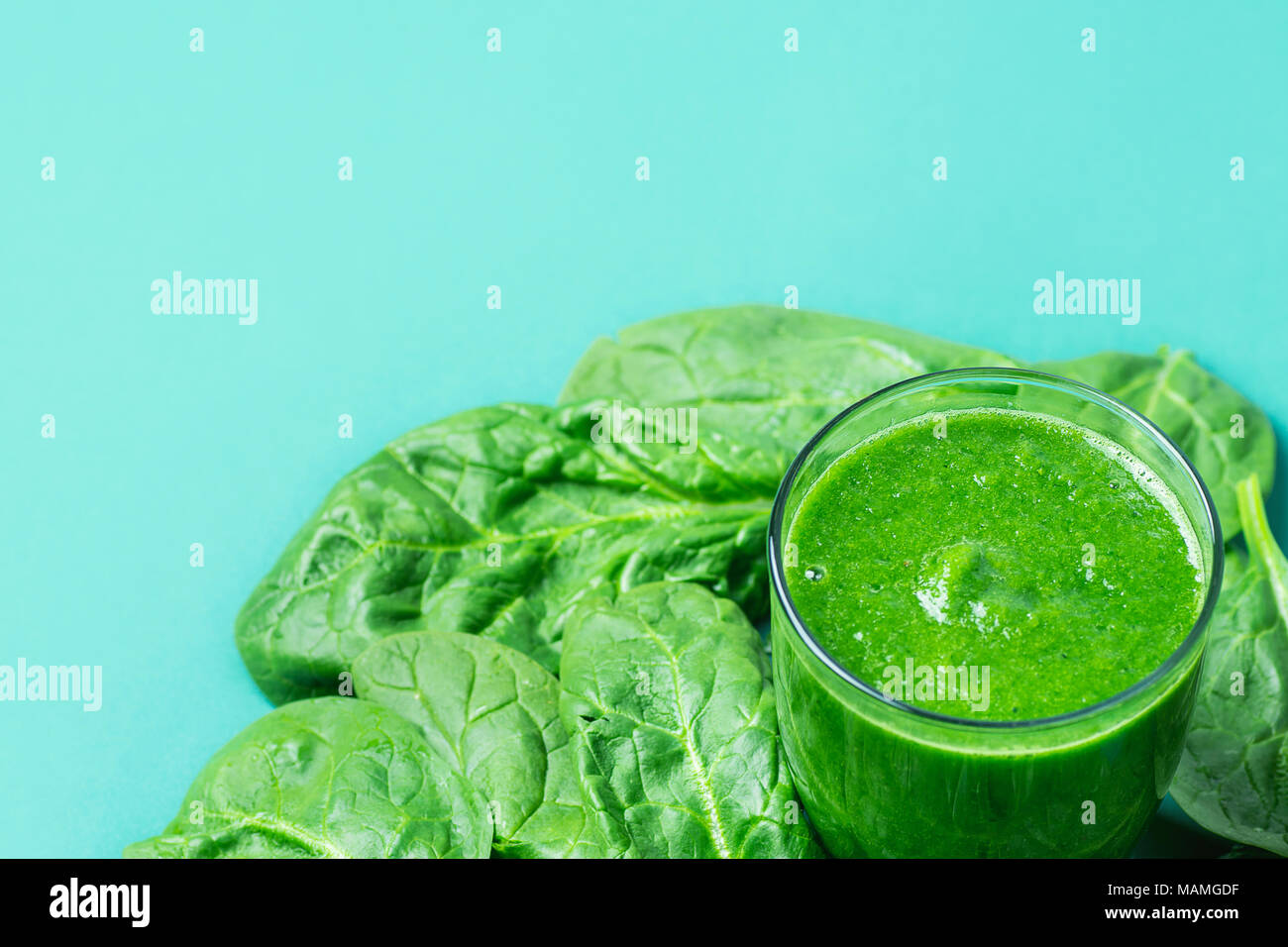 Glass with Green Fresh Smoothie from Leafy Greens Vegetables Fruits