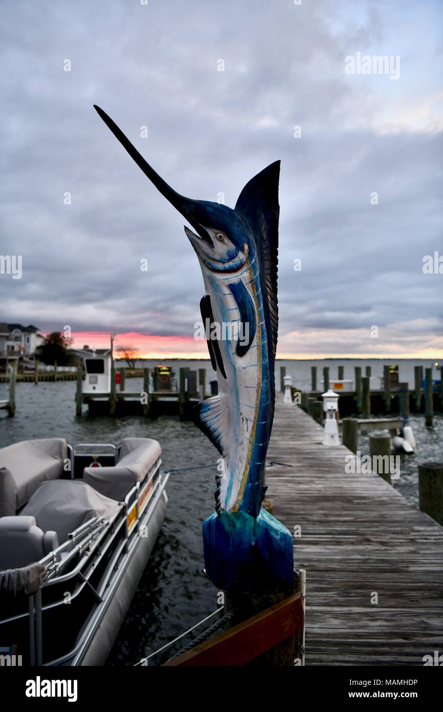 Swordfish statue carved from food and painted on a boat dock Stock Photo