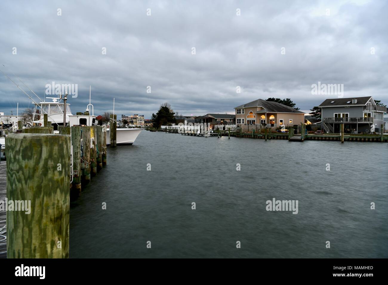 View of beautiful homes on a cloudy evening on Assawoman bay in Ocean City, Maryland, USA Stock Photo