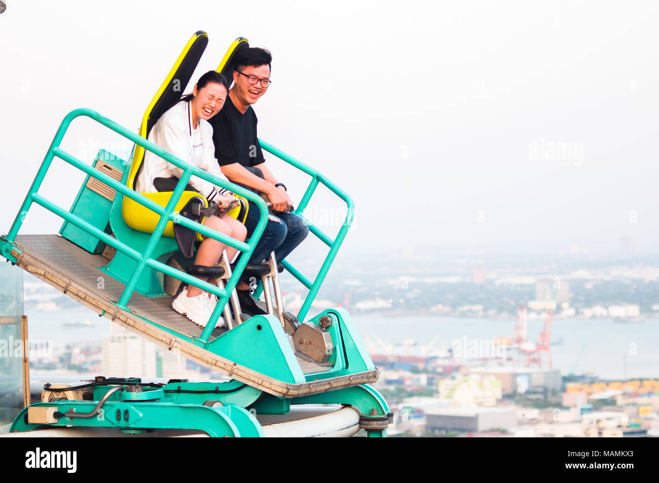 Thrill seekers ride the popular Edge Coaster on the 38th floor rooftop of the Crown Regency Building in Osmena Boulevard, Cebu City. Stock Photo