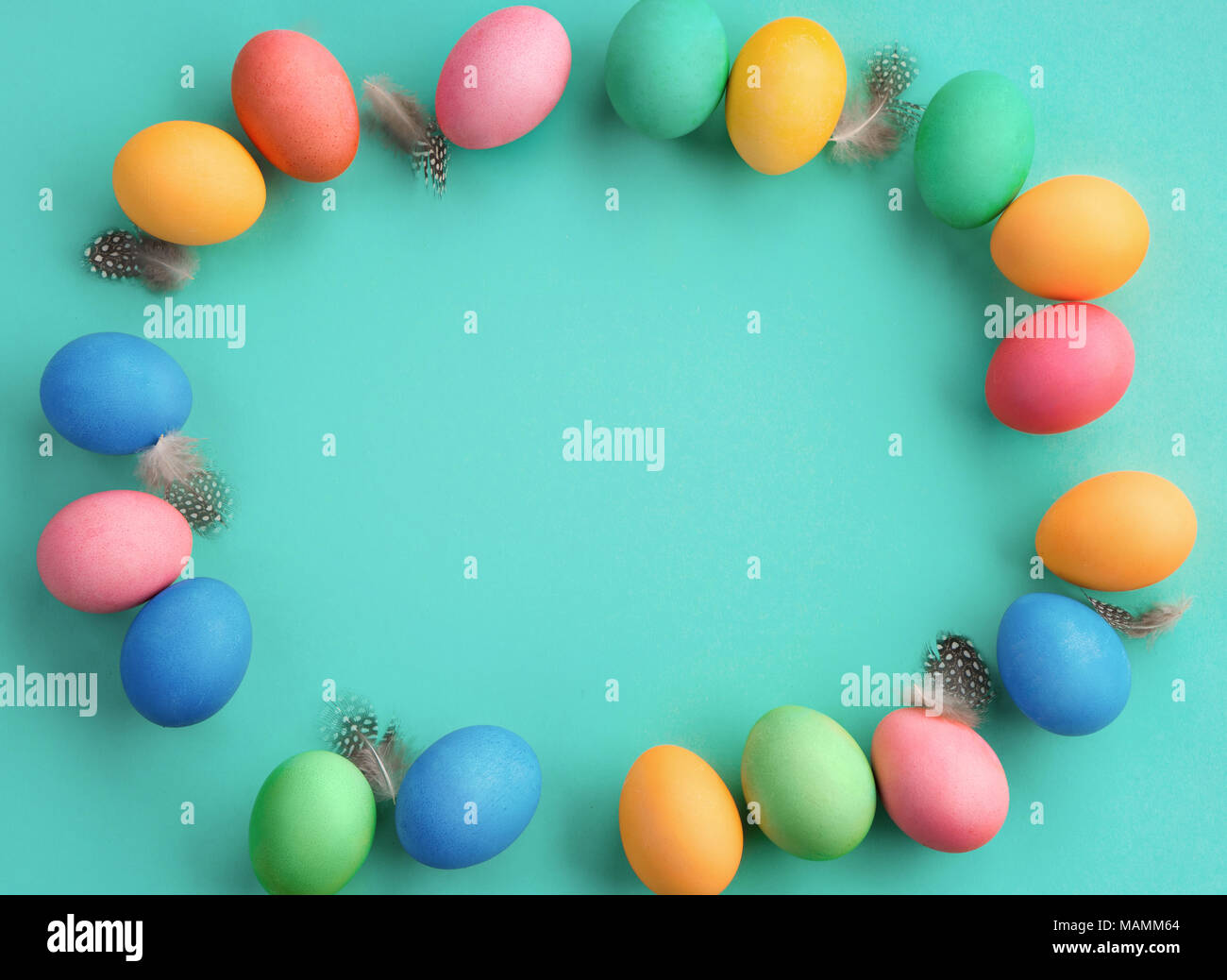 Happy Easter! Turquoise background with colorful easter eggs. Top view ...