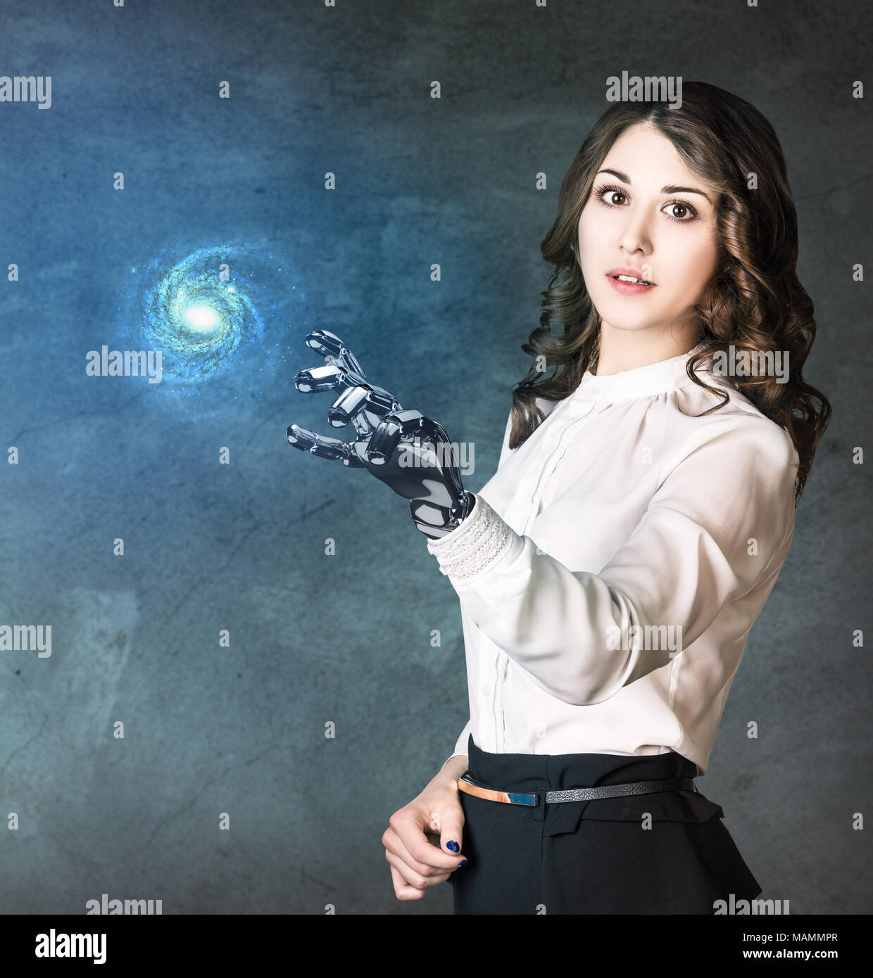 Young business woman with robot hand point on galaxy. Stock Photo