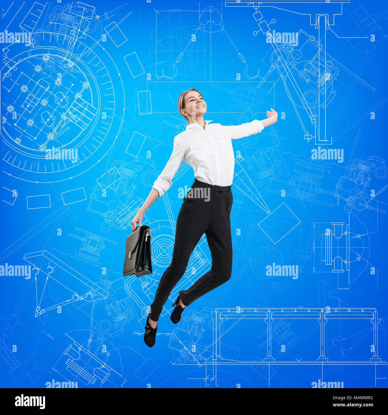 Business woman jumping over blueprint background. Stock Photo