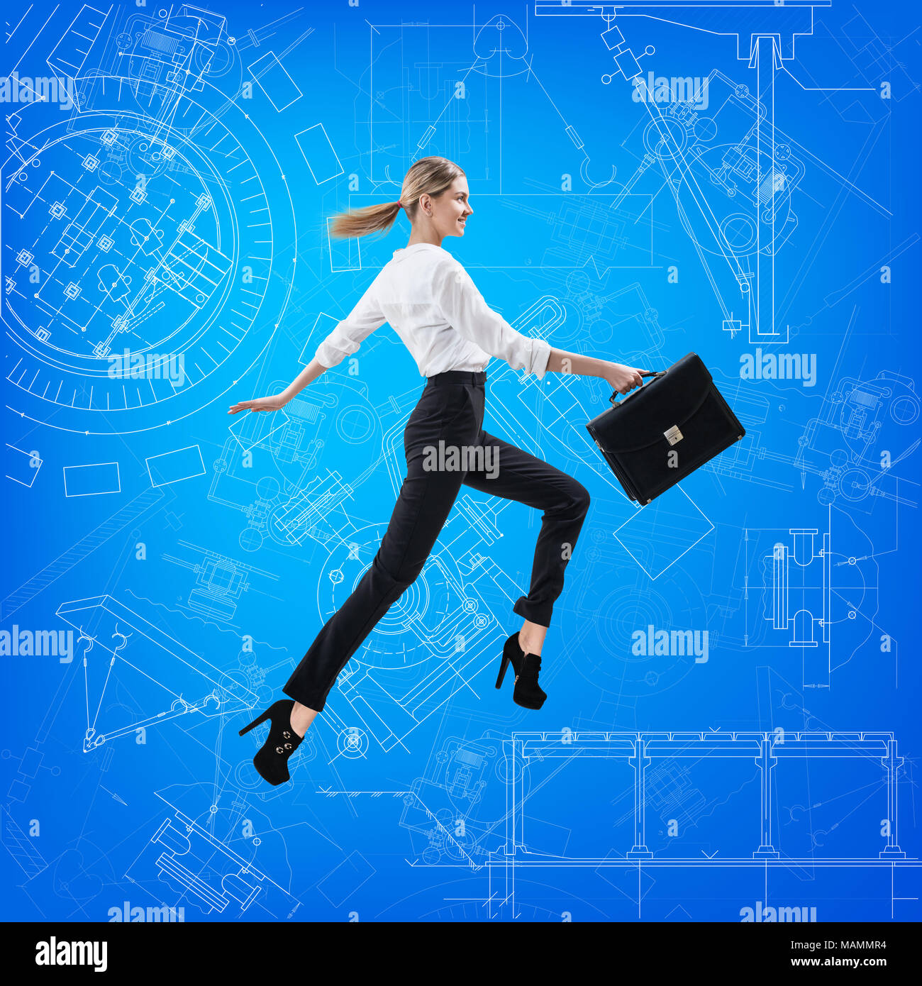 Business woman jumping over blueprint background. Stock Photo