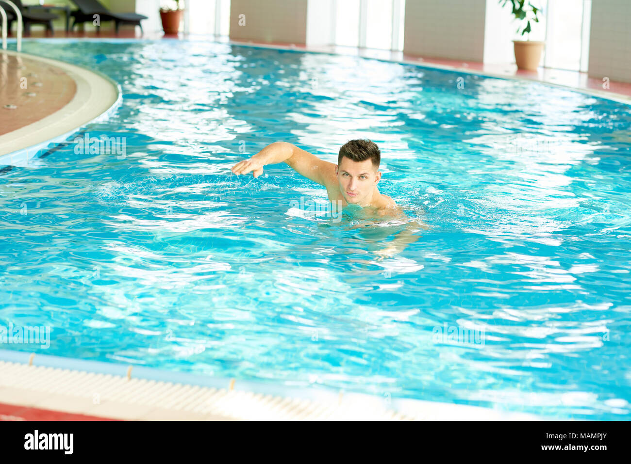 Young Man Swimming in Pool Stock Photo