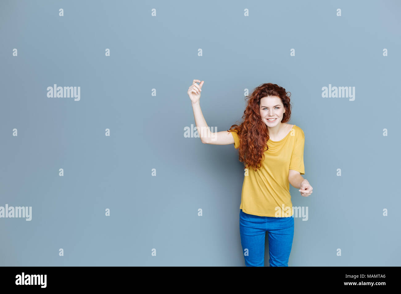 Delighted nice woman holding her hand up Stock Photo