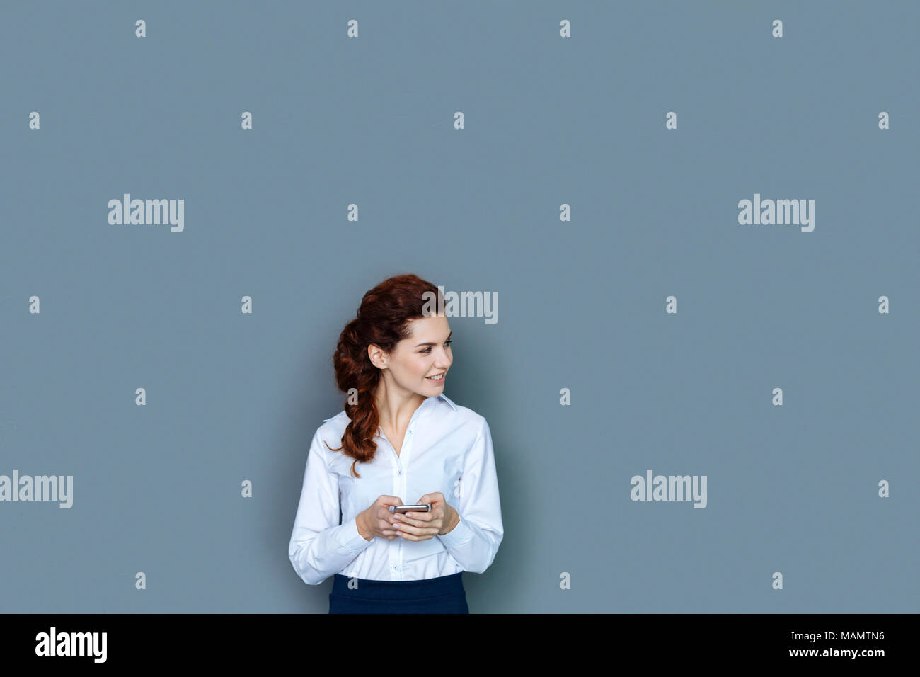 Delighted positive businesswoman looking aside Stock Photo