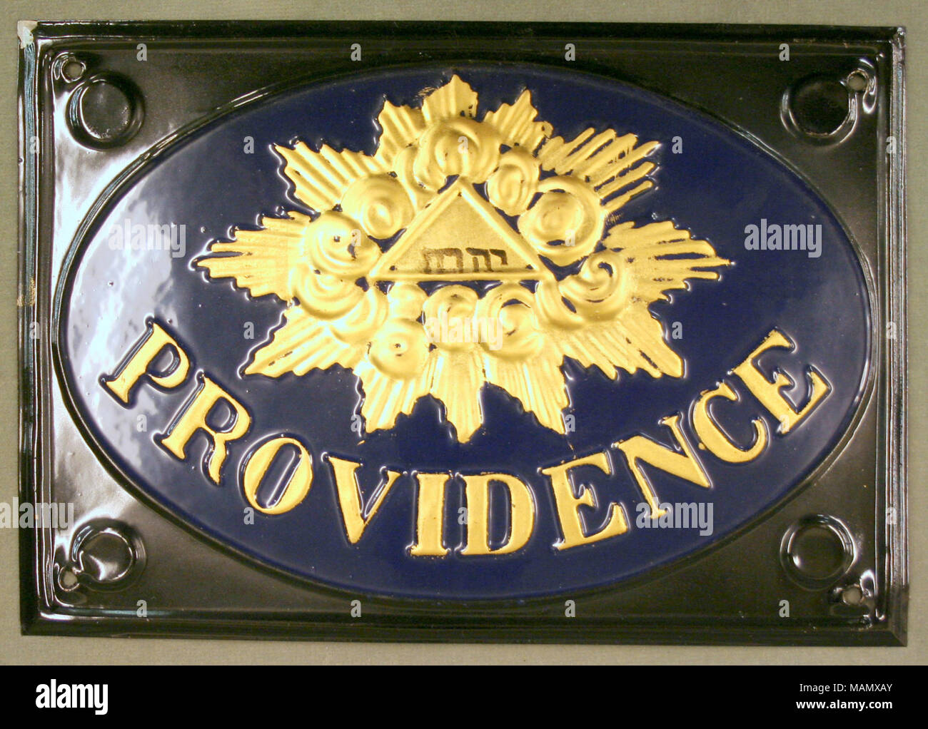 Pressed tin fire mark for La Providence Compagnie d'Assurances Contre l'Incendie in Paris, France showing raised gold emblem on dark blue oval and black background Title: Fire mark for La Providence Compagnie d'Assurances Contre l'Incendie in Paris, France  . after 1838. Stock Photo