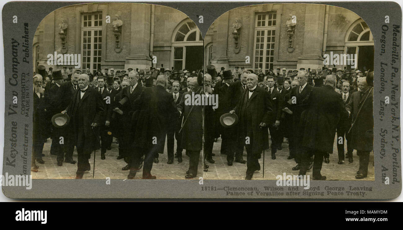 Horizontal, sepia stereocard showing a crowd of people outside the Palace of Versailles. Among those exiting the palace include Georges Clemenceau (France), Woodrow Wilson (United States), and David Lloyd George (Great Britain). Keystone Stereograph number 18781. The title reads: 'Clemenceau, Wilson and Lloyd George Leaving Palace of Versailles after Signing Peace Treaty.' Title: 'Leaving Palace of Versailles.'  . 28 June 1919. Keystone View Company Stock Photo