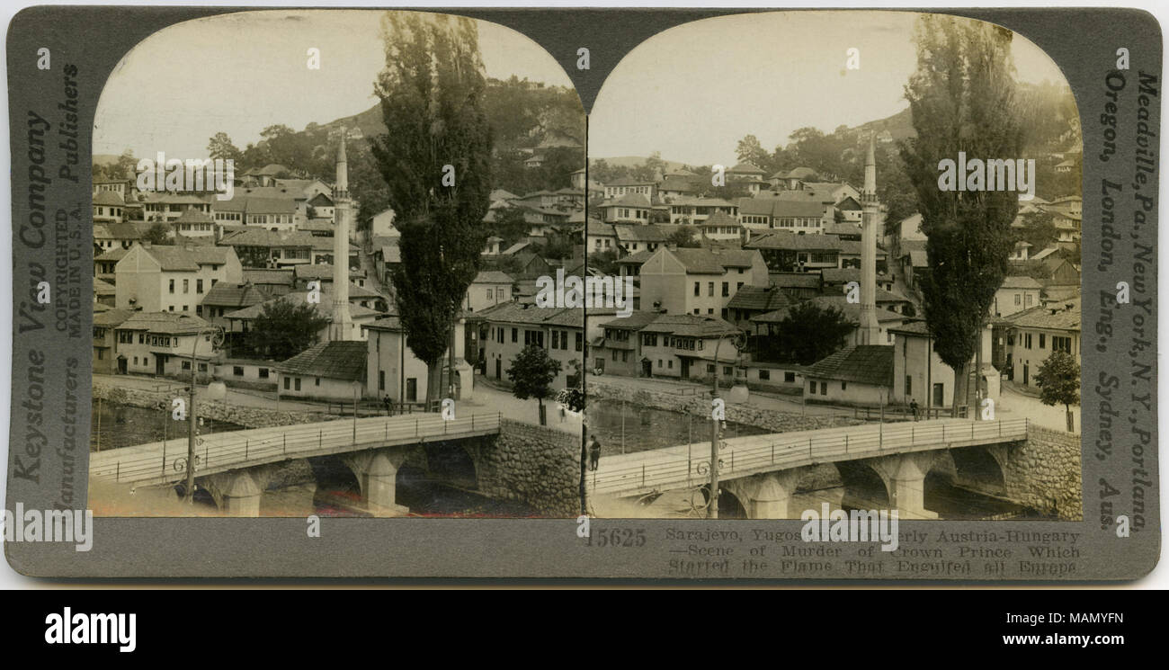 Horizontal, sepia stereocard showing view of Sarajevo, Bosnia and Herzegovina. In the foreground is a bridge spanning a river, and various buildings can be seen in the background. Keystone Stereograph number 15625. The title reads: 'Sarajevo, Yugoslavia, formerly Austria-Hungary - Scene of Murder of Crown Prince Which Started the Flame That Engulfed all Europe.' Title: 'Sarajevo, Jugo-Slavia - Scene of Murder of Crown Prince.'  . between circa 1914 and circa 1918. Keystone View Company Stock Photo